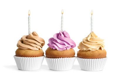 Photo of Delicious birthday cupcakes with candles on white background