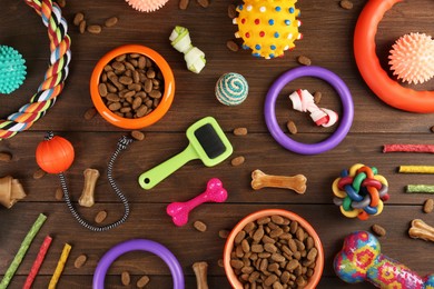 Flat lay composition with different pet goods on wooden background. Shop assortment