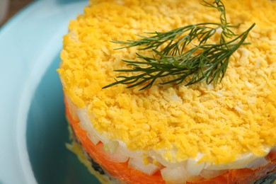 Photo of Traditional russian salad Mimosa served on plate, closeup