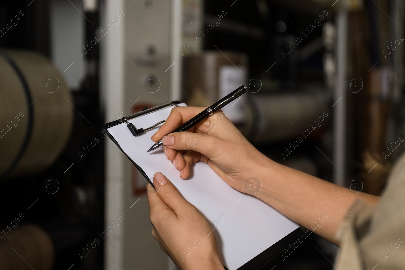 Photo of Woman with clipboard in wholesale warehouse, closeup