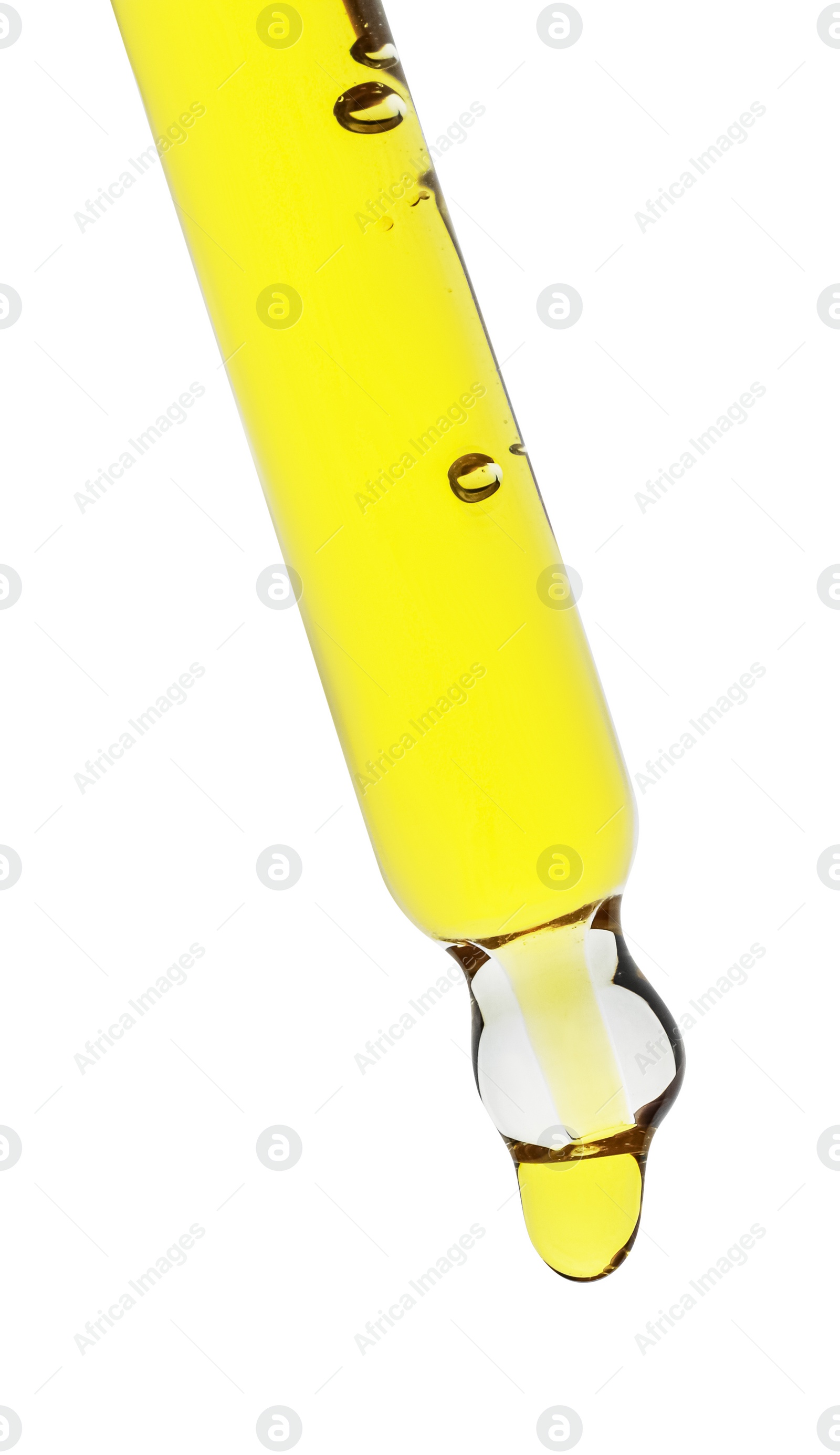 Photo of Dripping yellow facial serum from pipette on white background, closeup