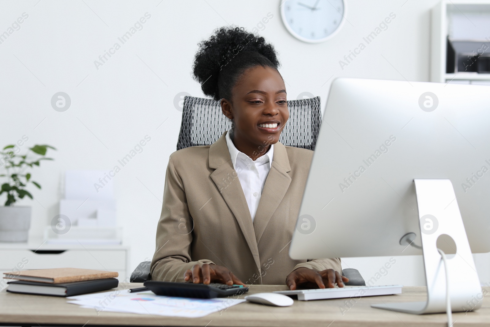 Photo of Professional accountant working on computer at wooden desk in office