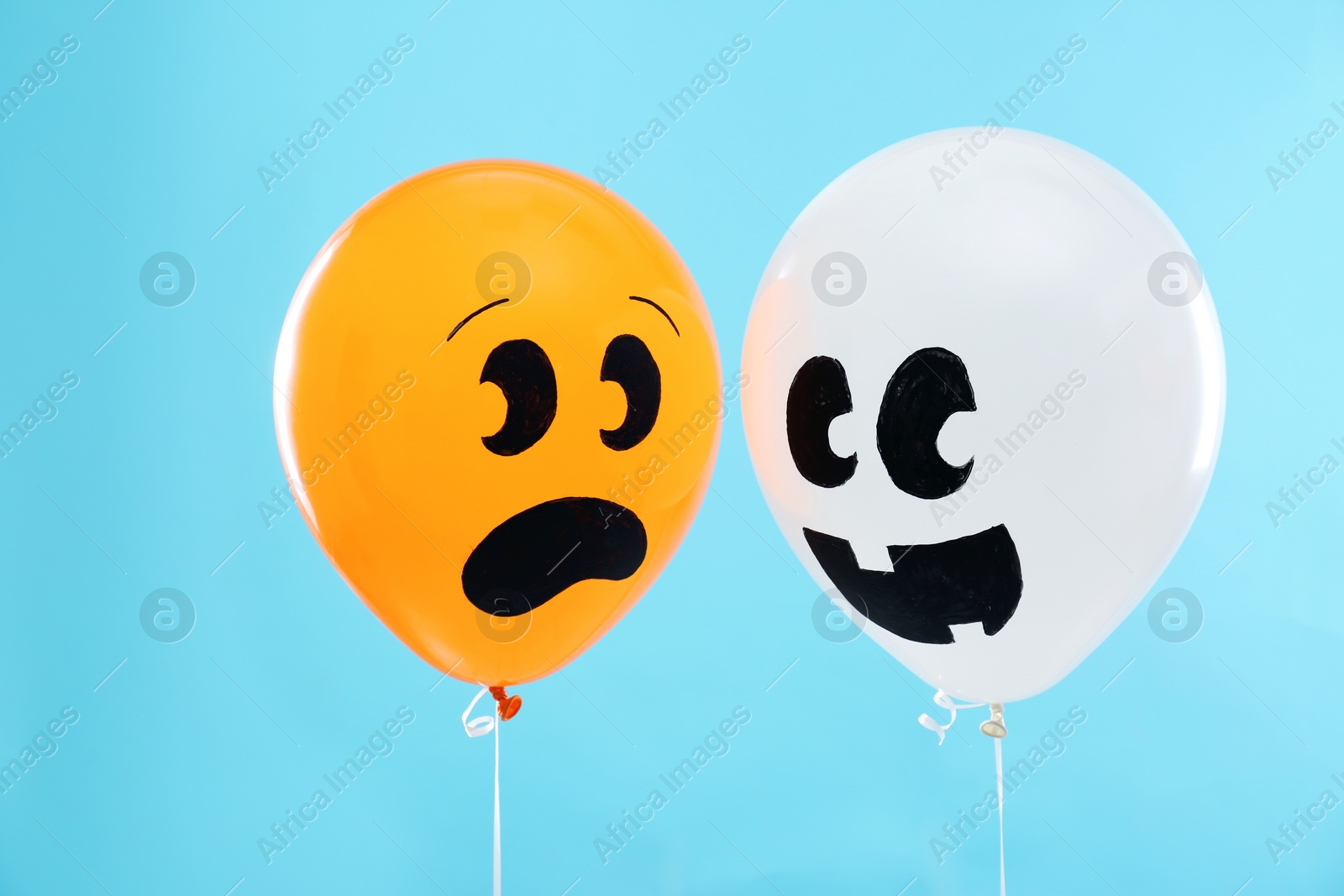 Photo of Colorful balloons for Halloween party on blue background