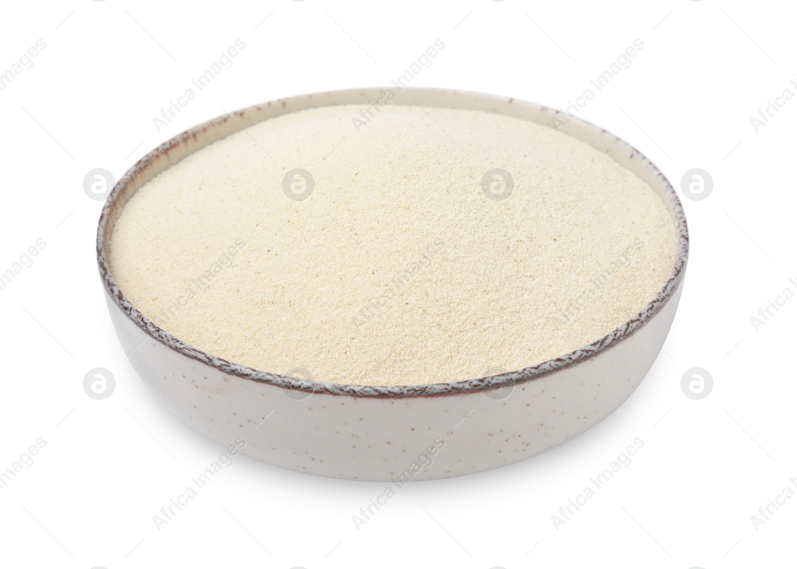 Photo of Bowl of uncooked organic semolina isolated on white