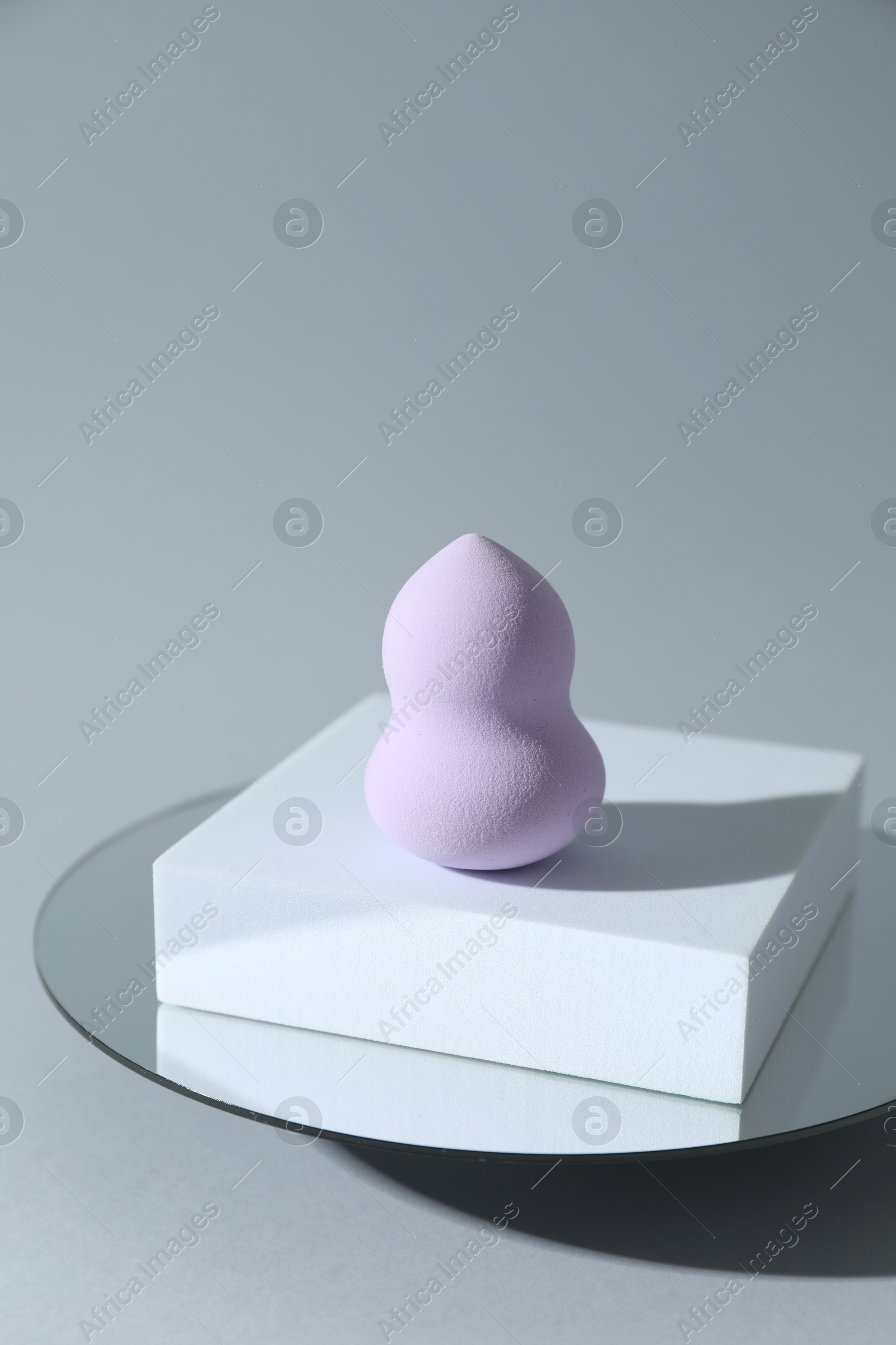 Photo of Stylish presentation of makeup sponge on light grey background