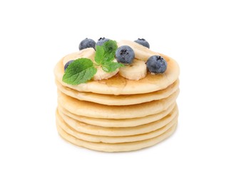 Delicious pancakes with banana slices, blueberries and mint isolated on white