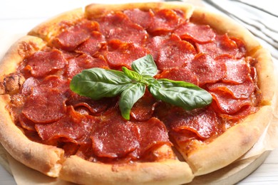 Photo of Tasty pepperoni pizza on white table, closeup