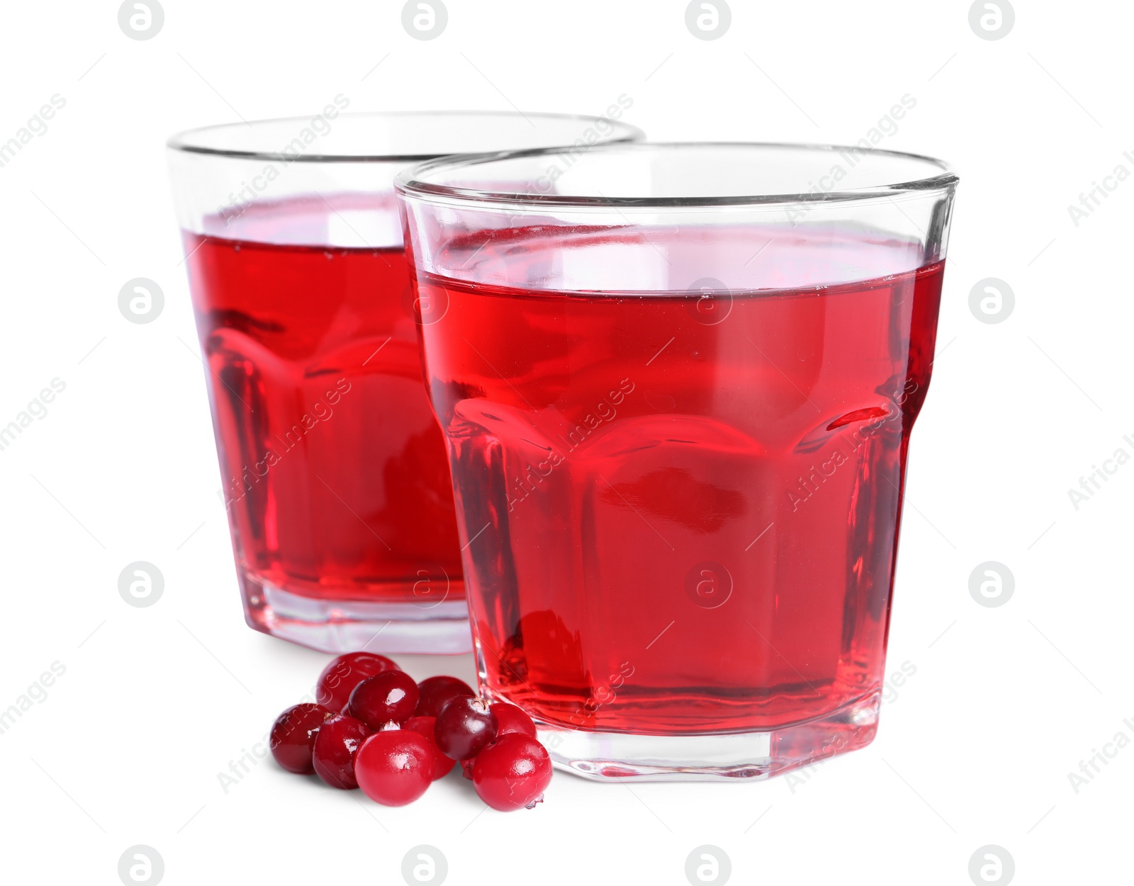 Photo of Tasty cranberry juice in glasses and fresh berries isolated on white