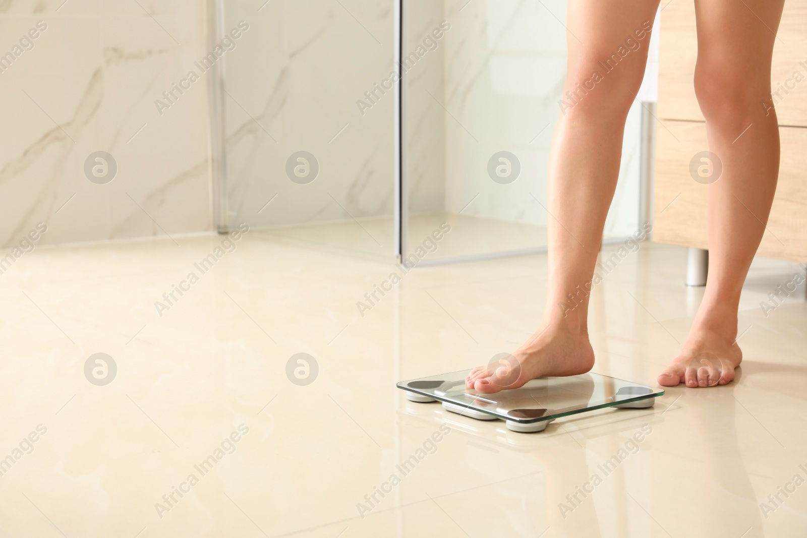 Photo of Woman stepping on floor scales in bathroom, space for text. Overweight problem