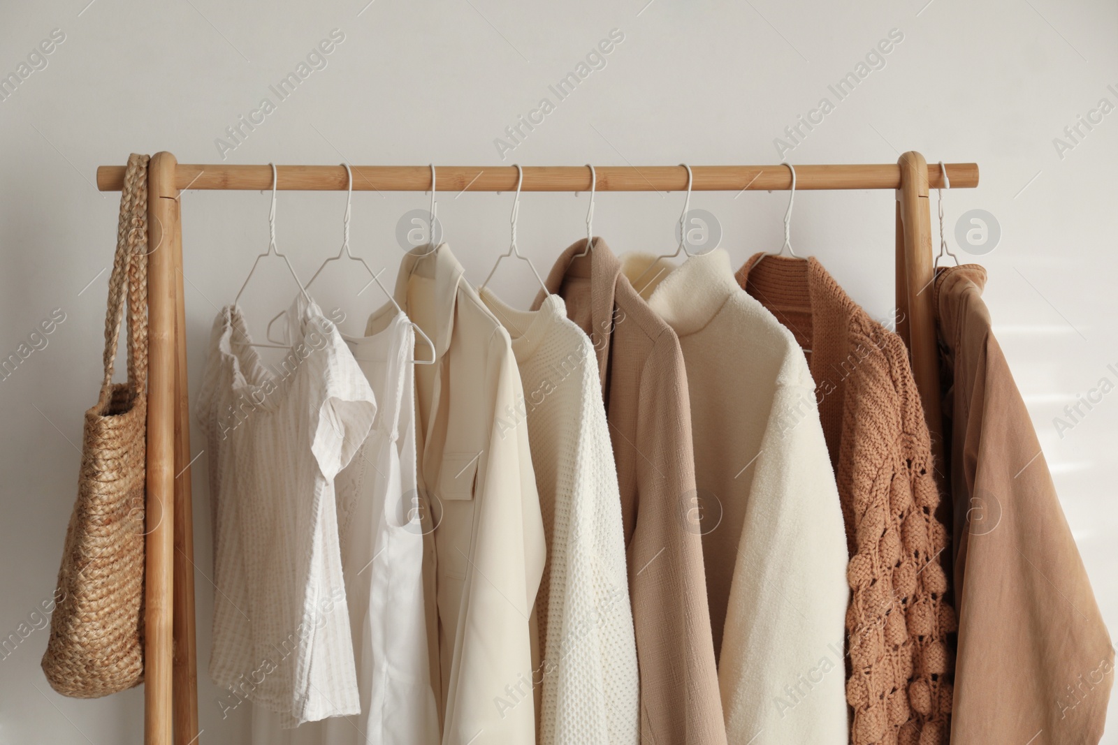 Photo of Rack with stylish women's clothes indoors. Modern interior design