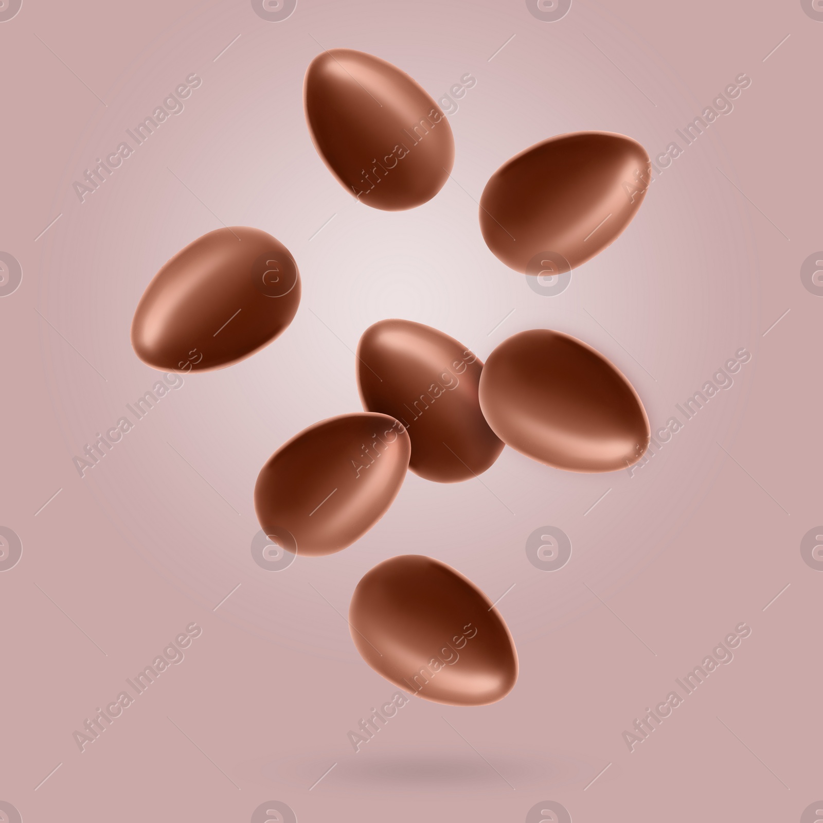 Image of Many chocolate eggs falling on dusty pink background