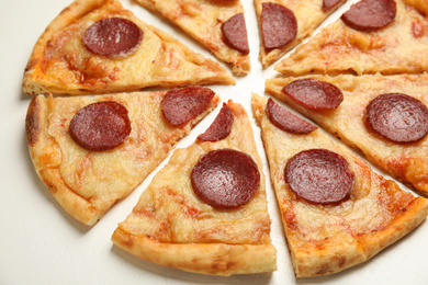 Photo of Tasty pepperoni pizza on white table, closeup