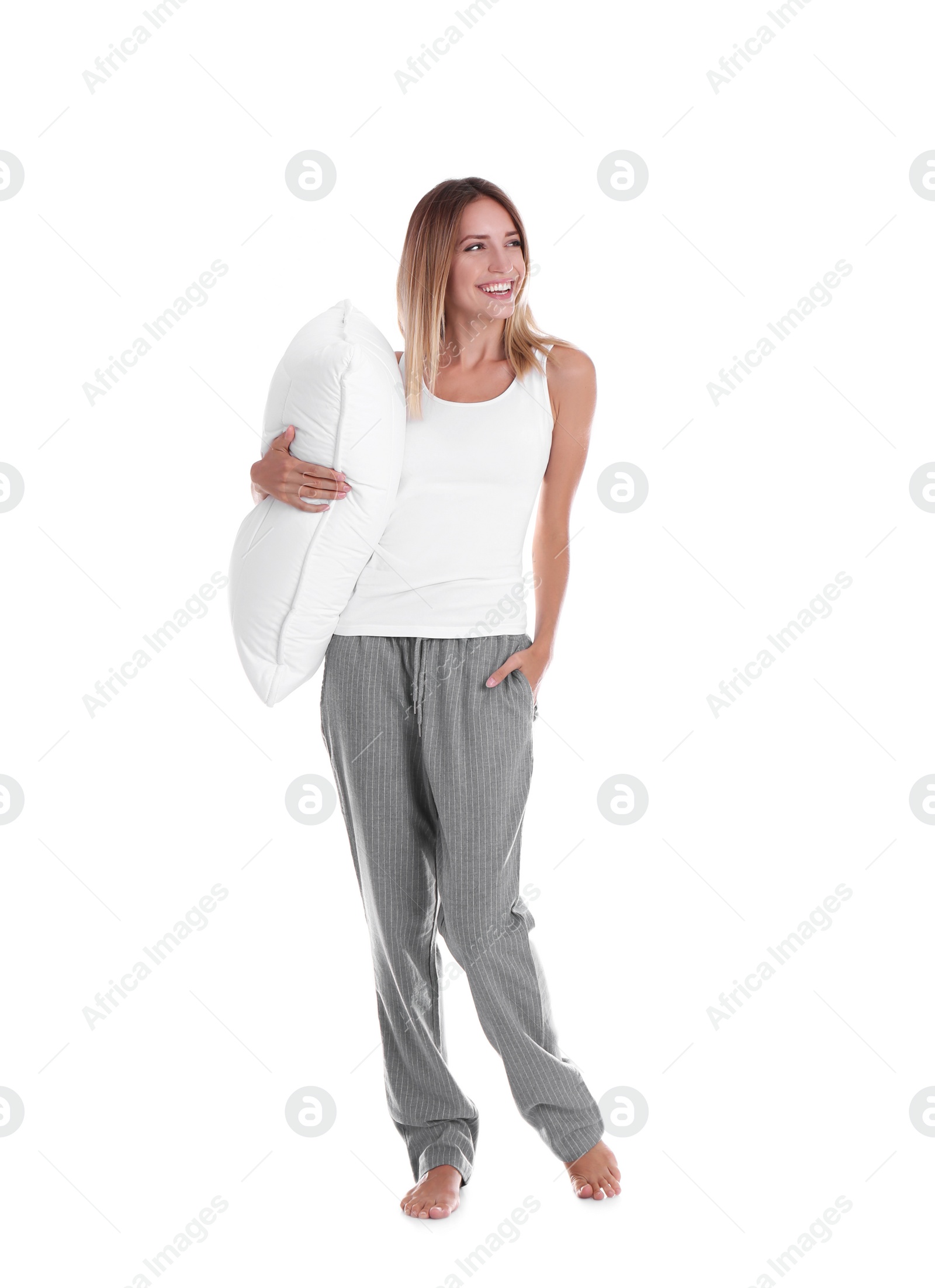 Photo of Happy woman in pajamas with pillow on white background