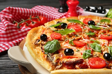 Photo of Tasty fresh homemade pizza on table, closeup