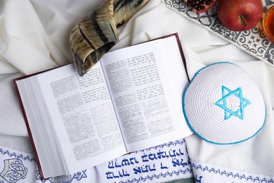 Photo of Flat lay composition with Rosh Hashanah holiday symbols on fabric