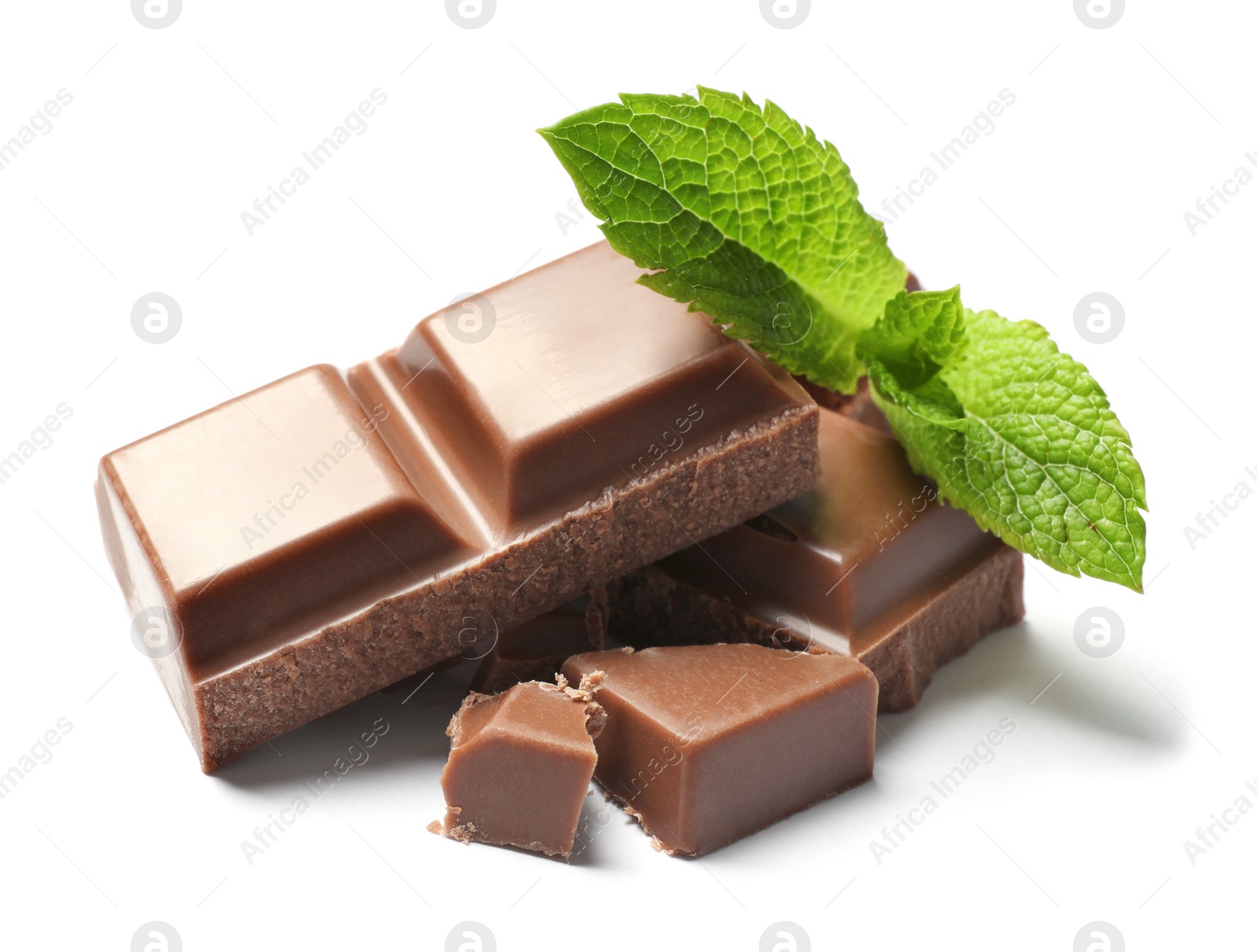 Photo of Pieces of milk chocolate with mint on white background