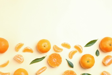 Photo of Composition with tangerines and leaves on color background, flat lay. Space for text