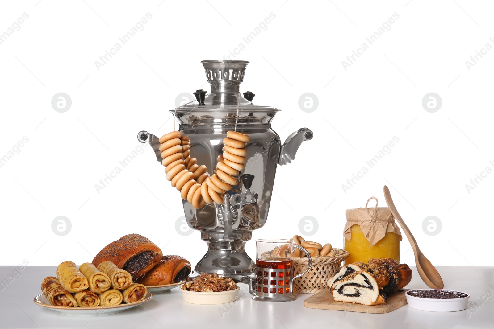 Photo of Traditional Russian samovar with treats isolated on white