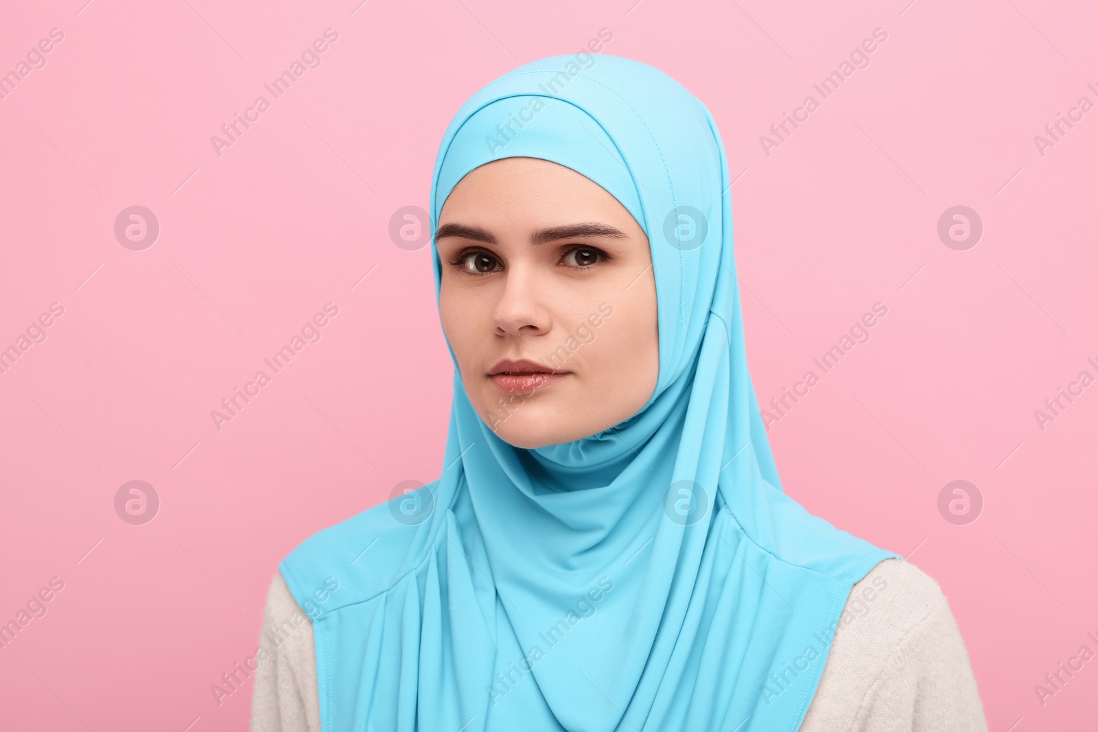 Photo of Portrait of Muslim woman in hijab on pink background