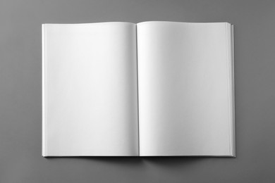 Photo of Open blank brochure on light grey background, top view