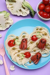 Photo of Creative serving for kids. Plate with cute octopuses madesausages, pasta and vegetables on violet table, flat lay