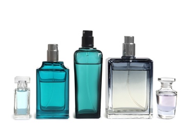 Different perfume bottles on white background