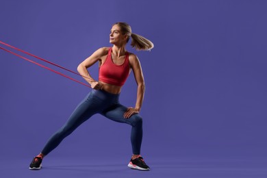 Photo of Athletic woman exercising with elastic resistance band on purple background. Space for text