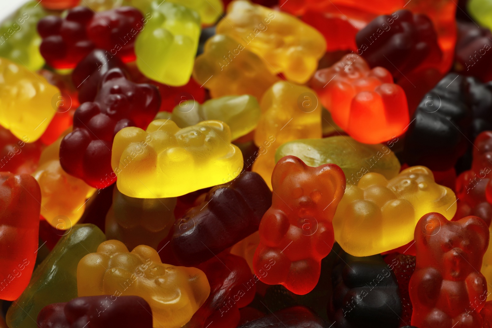 Photo of Delicious gummy bear candies as background, closeup