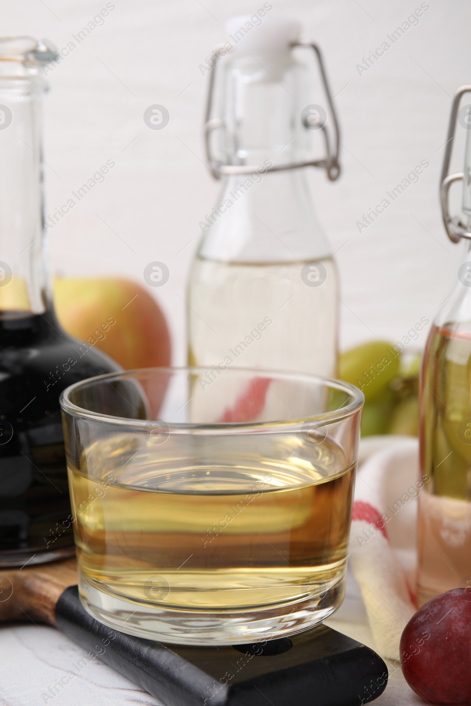 Photo of Different types of vinegar on white table