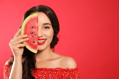 Photo of Beautiful young woman with watermelon on red background. Space for text