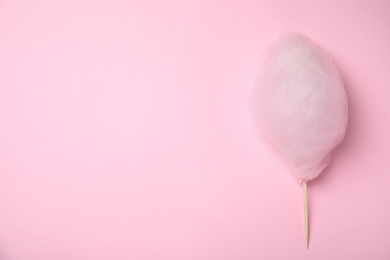 Photo of Sweet cotton candy on pink background, top view. Space for text