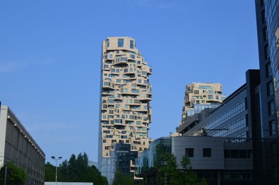 Exterior of beautiful modern skyscrapers against blue sky