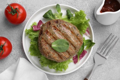 Delicious vegan cutlets served on light grey table, flat lay