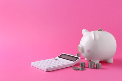 Financial savings. Piggy bank, coins and calculator on pink background, space for text