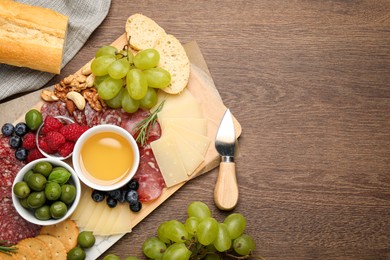 Photo of Snack set with delicious Parmesan cheese on wooden table, flat lay. Space for text