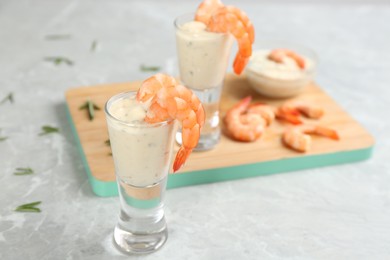 Photo of Shrimp cocktail and tartar sauce on marble table