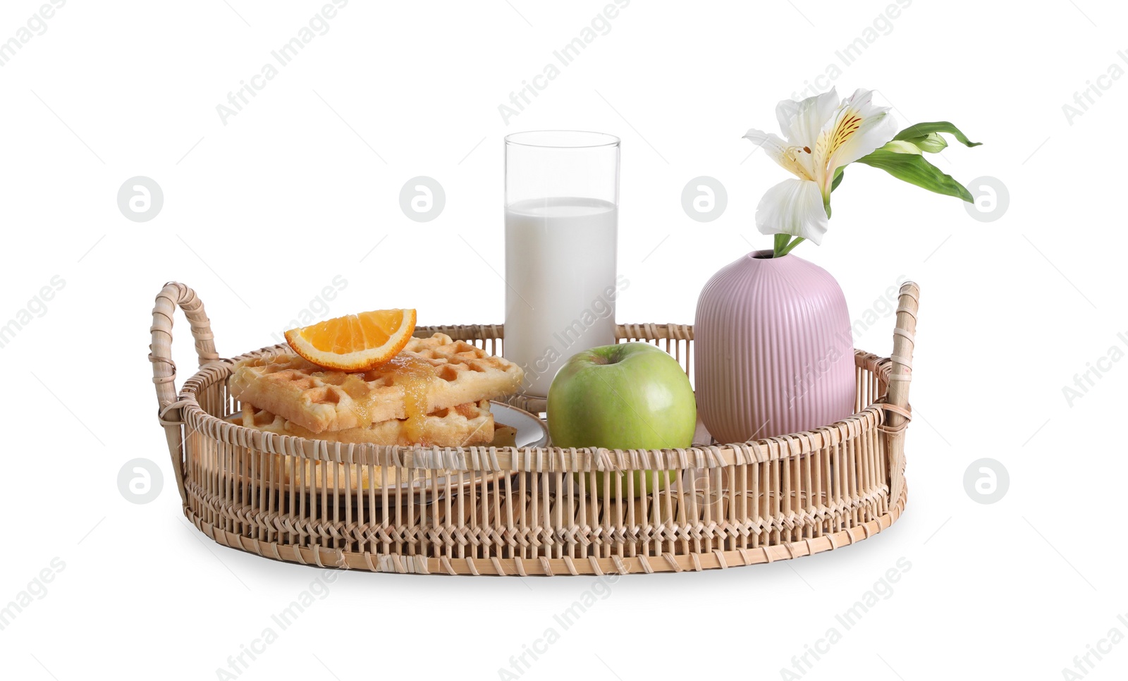 Photo of Wicker tray with delicious breakfast and beautiful flower on white background