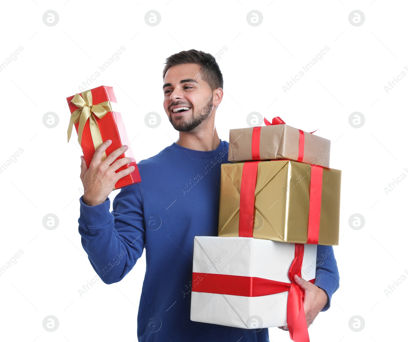 Photo of Happy young man holding Christmas gifts on white background