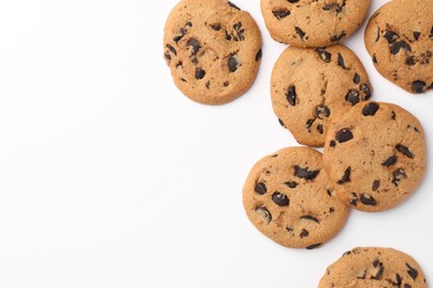 Many delicious chocolate chip cookies on white background, flat lay. Space for text