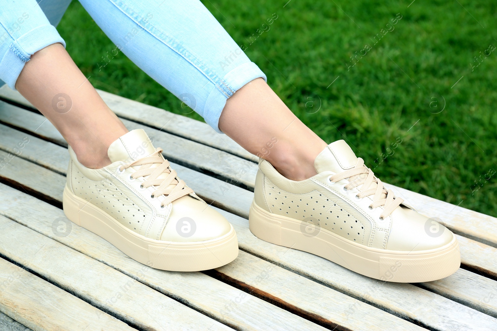 Photo of Woman wearing comfortable stylish shoes outdoors, closeup