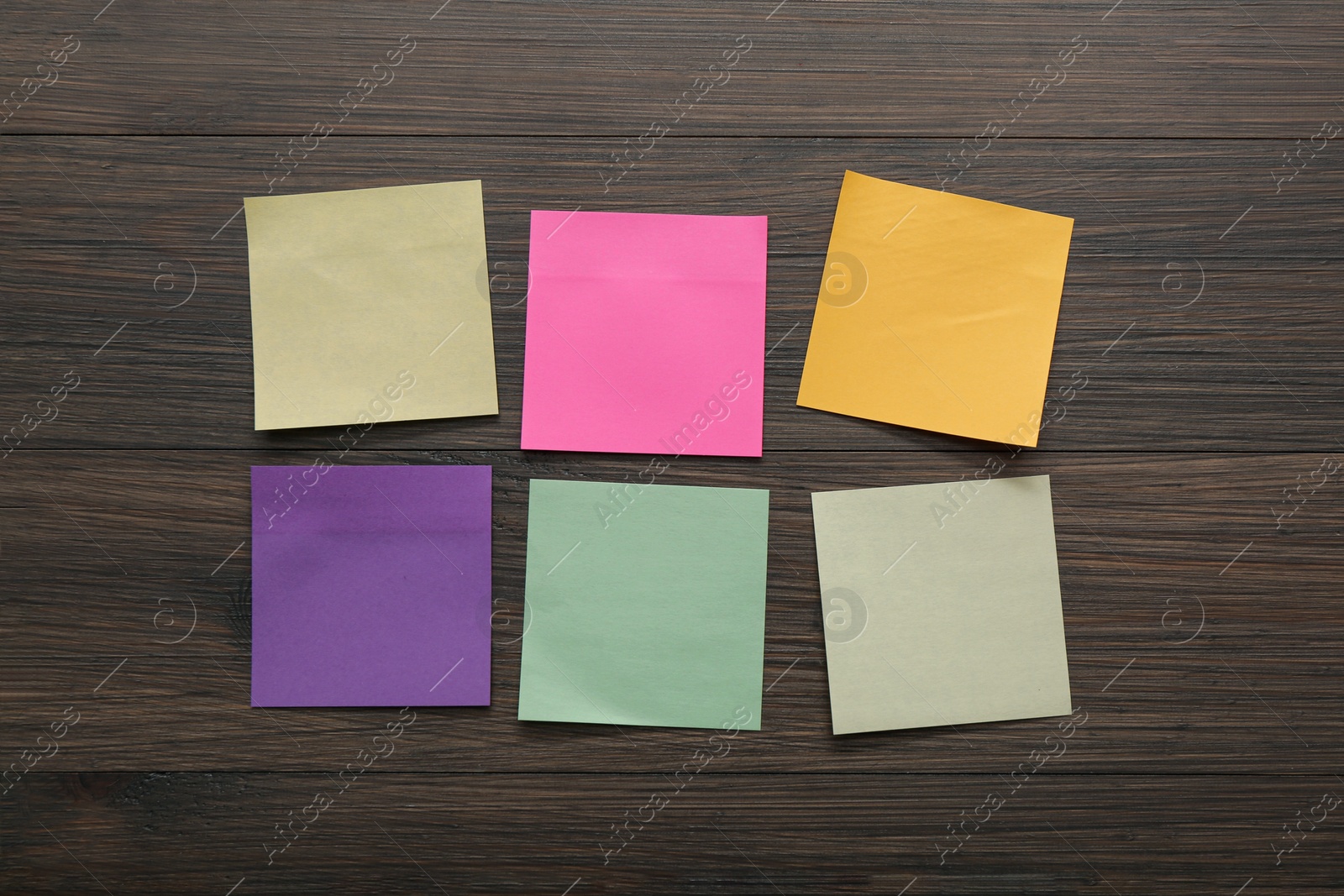 Photo of Blank colorful stickers on wooden table, flat lay