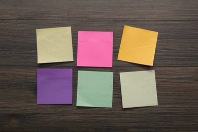 Photo of Blank colorful stickers on wooden table, flat lay