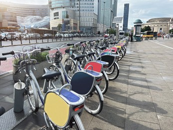 Photo of Many bicycles parked outdoors. Bike rental service