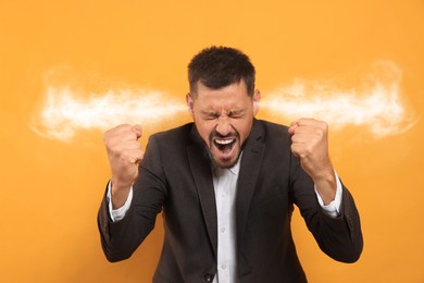 Image of Aggressive man with steam coming out of his ears on orange background
