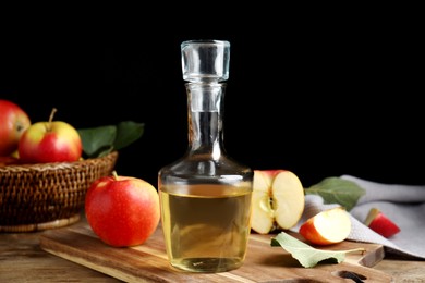Photo of Natural apple vinegar and fresh fruits on wooden table