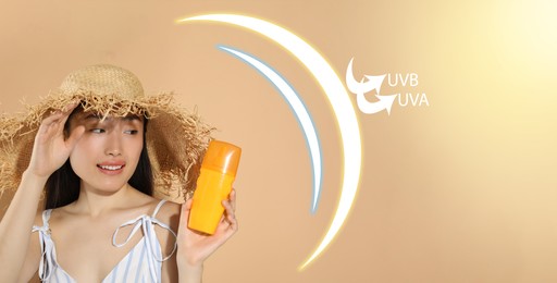 Sun protection product as barrier against UVA and UVB, banner design. Beautiful young woman with bottle of sunscreen against beige background