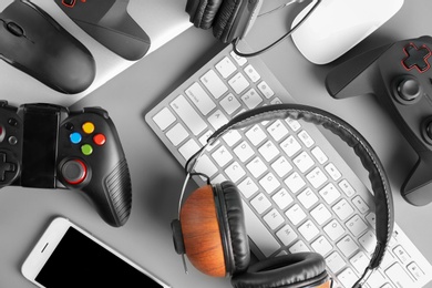 Photo of Gamepads, mice, headphones and keyboard on table