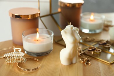 Beautiful female body shaped candle on wooden table. Stylish decor