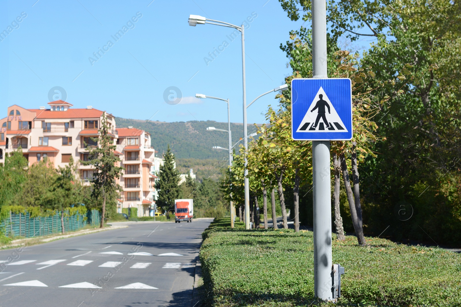 Photo of Pedestrian Crossing road sign on city street. Space for text