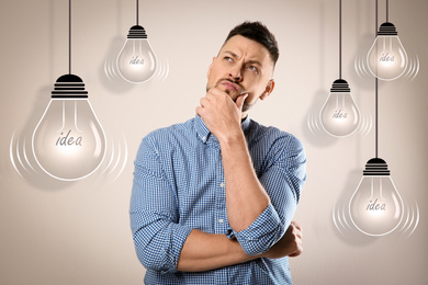 Image of Lightbulbs illustration and thoughtful man in casual outfit on beige background. Business idea